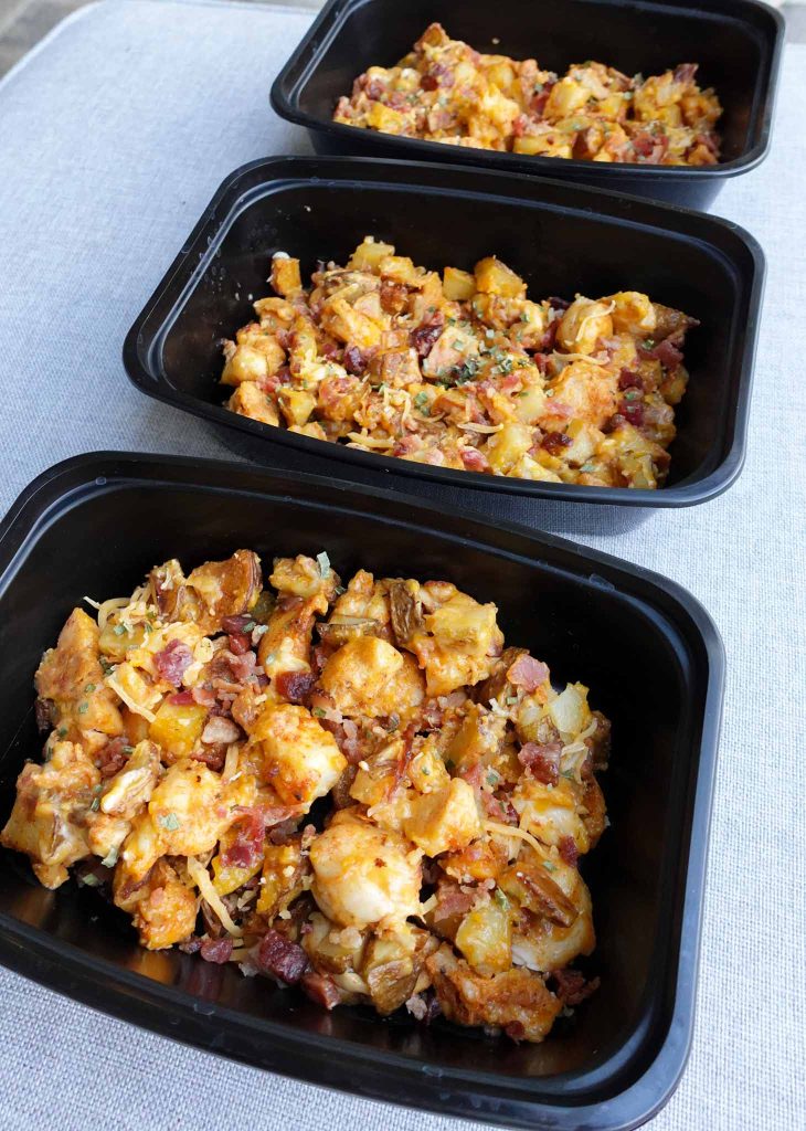 loaded potatoes, bacon, cheese in meal prep container